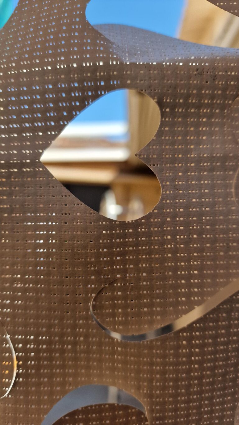 Primer plano de material con patrón de corte intrincado, con forma de corazón